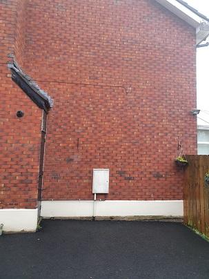 comes through the wall down to the gas meter box on left hand side